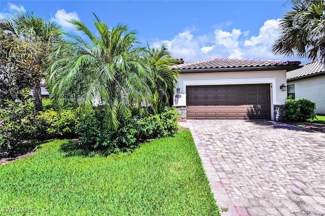 3742 Treasure Cove Cir, Naples, FL 34114 - mediterranean / spanish home with decorative driveway, stucco siding, an attached garage, and a tile roof