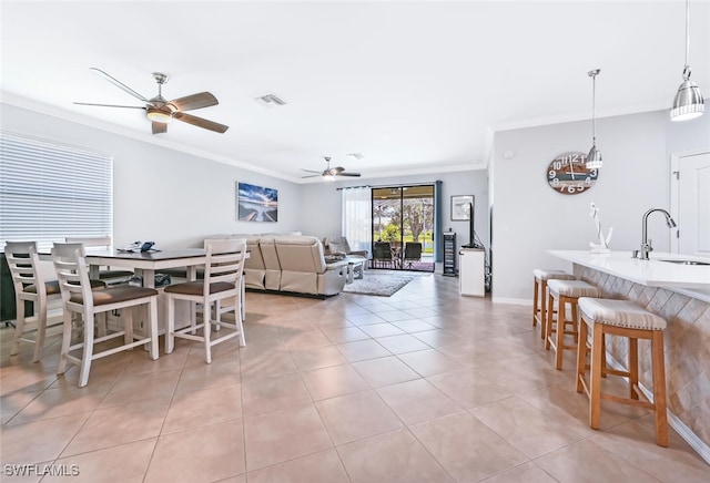 3742 Treasure Cove Cir, Naples, FL 34114 - dining area featuring crown molding, ceiling fan, light tile patterned floors, and baseboards