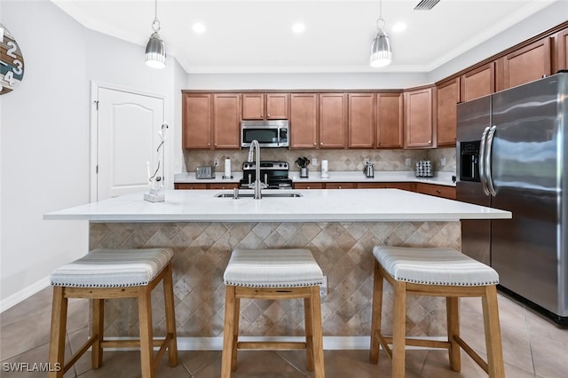 3742 Treasure Cove Cir, Naples, FL 34114 - kitchen featuring stainless steel appliances, a sink, light countertops, decorative light fixtures, and a center island with sink