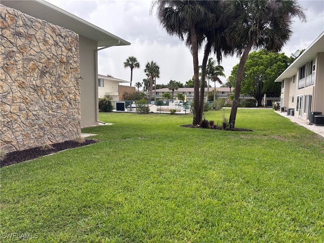339 Joel Blvd Unit 221, Lehigh Acres, FL 33936 - view of grassy yard with cooling unit