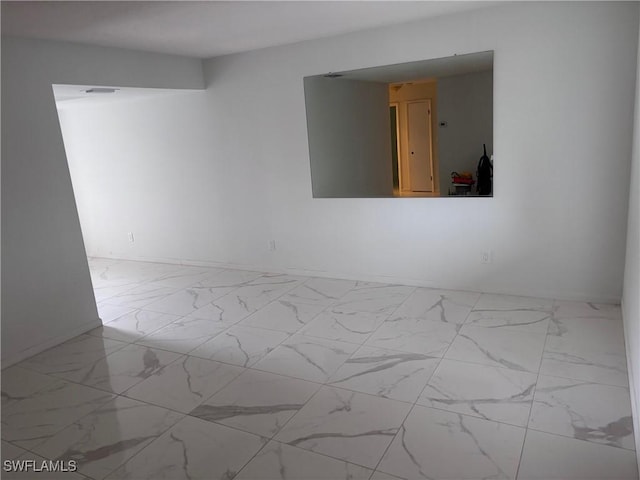 339 Joel Blvd Unit 221, Lehigh Acres, FL 33936 - spare room with marble look tiles and baseboards