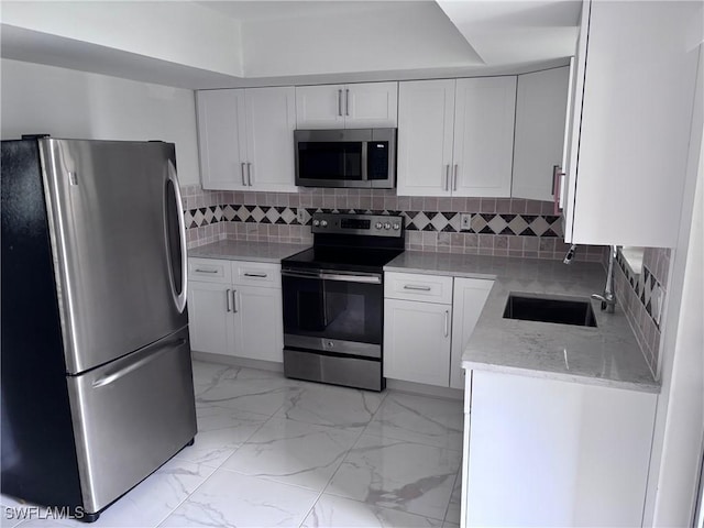 339 Joel Blvd Unit 221, Lehigh Acres, FL 33936 - kitchen with appliances with stainless steel finishes, a sink, light marble finish flooring, and white cabinets