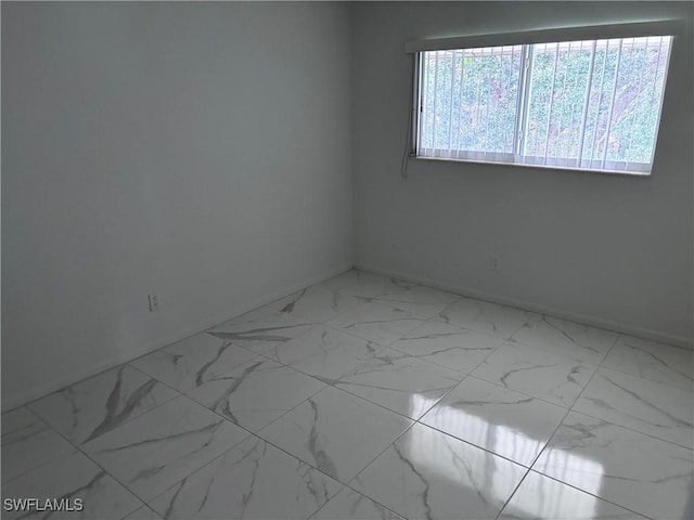 339 Joel Blvd Unit 221, Lehigh Acres, FL 33936 - empty room featuring marble finish flooring and baseboards
