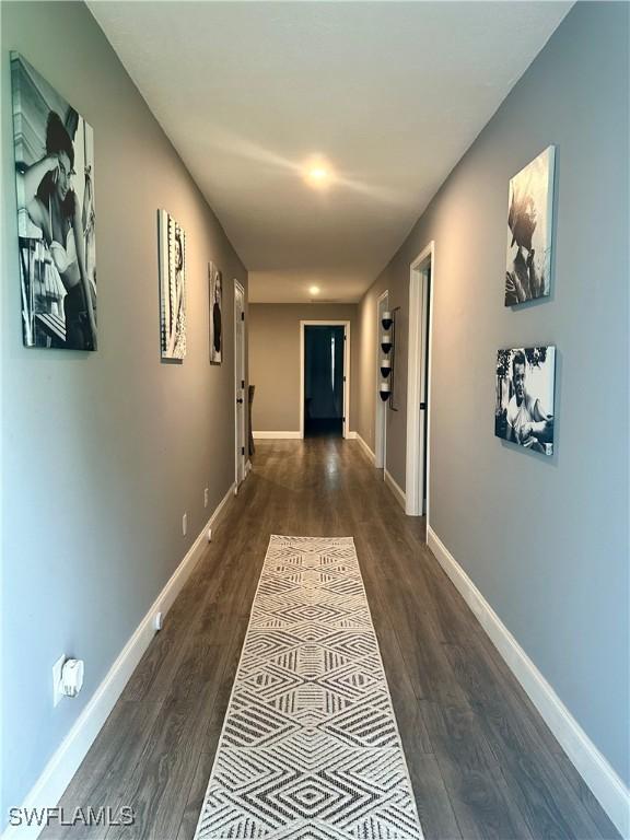 758 105th Ave N, Naples, FL 34108 - hall with dark wood-style flooring and baseboards