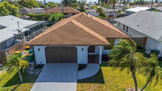 758 105th Ave N, Naples, FL 34108 - view of front of home with a shingled roof, a residential view, driveway, stucco siding, and an attached garage