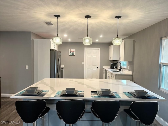 758 105th Ave N, Naples, FL 34108 - kitchen featuring stainless steel fridge with ice dispenser, a sink, baseboards, white cabinetry, and dark wood-type flooring
