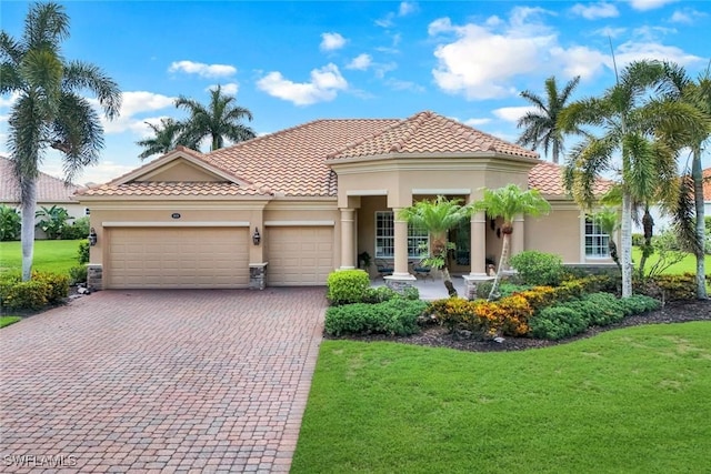 10026 Lions Bay Ct, Naples, FL 34120 - mediterranean / spanish-style house with a garage, decorative driveway, a front lawn, and stucco siding