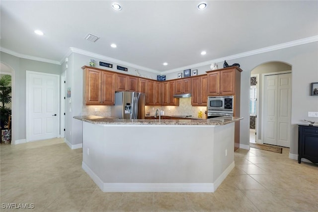10026 Lions Bay Ct, Naples, FL 34120 - kitchen with stainless steel appliances, arched walkways, light tile patterned floors, tasteful backsplash, and crown molding