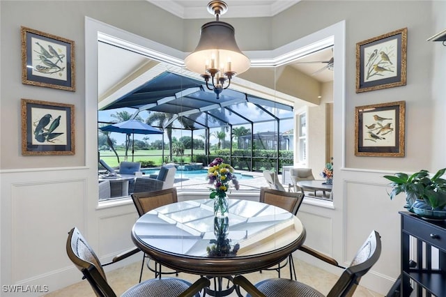10026 Lions Bay Ct, Naples, FL 34120 - dining room featuring a sunroom, a decorative wall, a ceiling fan, healthy amount of natural light, and a wainscoted wall