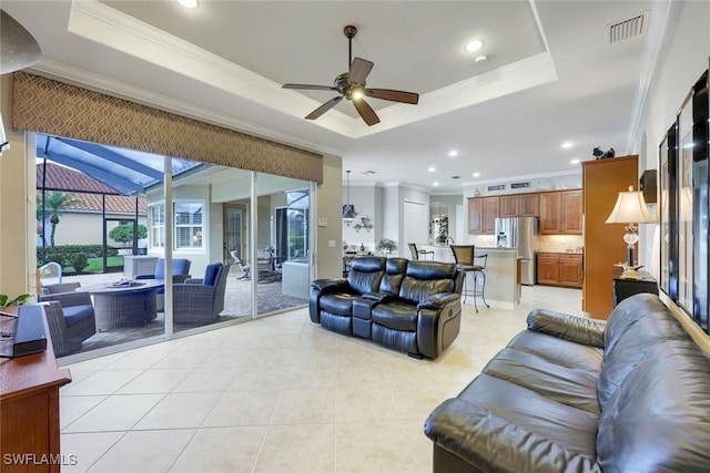 10026 Lions Bay Ct, Naples, FL 34120 - living area with ornamental molding, a tray ceiling, light tile patterned floors, a ceiling fan, and recessed lighting