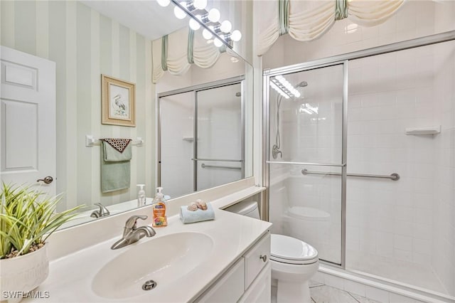 9121 Southmont Cv Unit 204, Fort Myers, FL 33908 - bathroom with toilet, wallpapered walls, a shower stall, vanity, and tile patterned floors