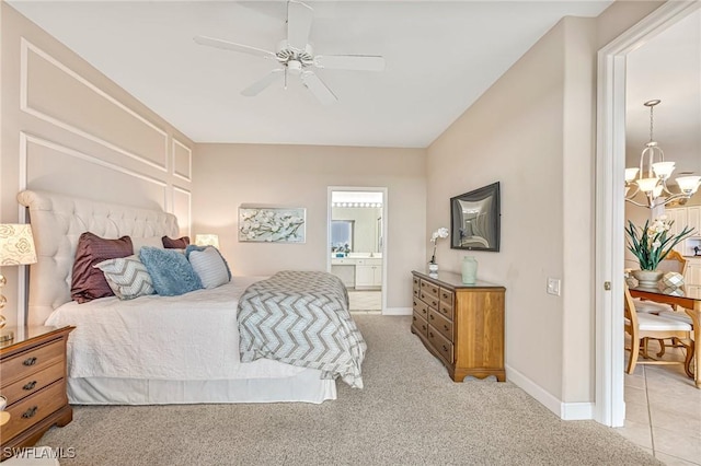 9121 Southmont Cv Unit 204, Fort Myers, FL 33908 - bedroom with a chandelier, light colored carpet, ensuite bathroom, and baseboards