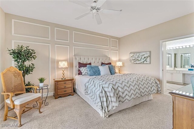9121 Southmont Cv Unit 204, Fort Myers, FL 33908 - bedroom with light colored carpet, connected bathroom, a decorative wall, a ceiling fan, and baseboards