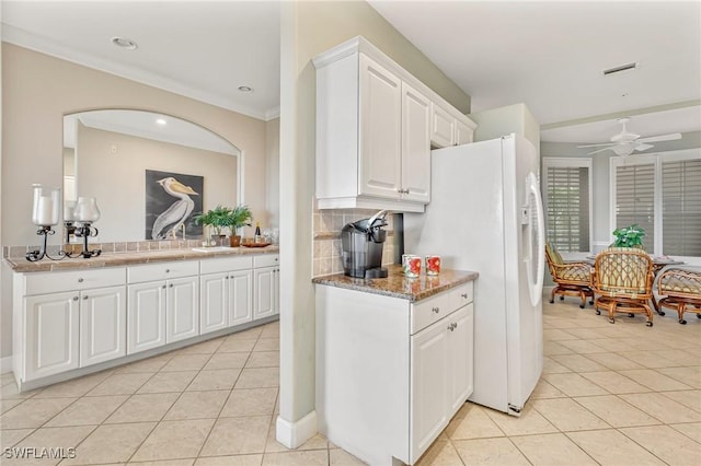 9121 Southmont Cv Unit 204, Fort Myers, FL 33908 - kitchen with light tile patterned floors, white fridge with ice dispenser, decorative backsplash, white cabinets, and a ceiling fan
