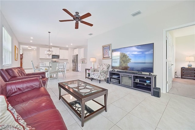 2113 Summersweet Dr, Alva, FL 33920 - living room featuring a ceiling fan, light tile patterned flooring, and a chandelier