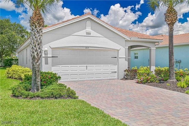 2113 Summersweet Dr, Alva, FL 33920 - mediterranean / spanish-style home featuring stucco siding, a tile roof, and driveway