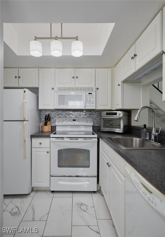 3297 Royal Canadian Trce Unit 2, Fort Myers, FL 33907 - kitchen featuring white appliances, a sink, white cabinetry, and dark countertops