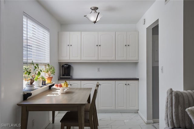 3297 Royal Canadian Trce Unit 2, Fort Myers, FL 33907 - dining room with light marble finish floors and baseboards