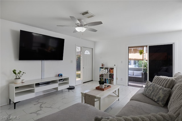 3297 Royal Canadian Trce Unit 2, Fort Myers, FL 33907 - living room featuring marble look tile flooring, a ceiling fan, and baseboards