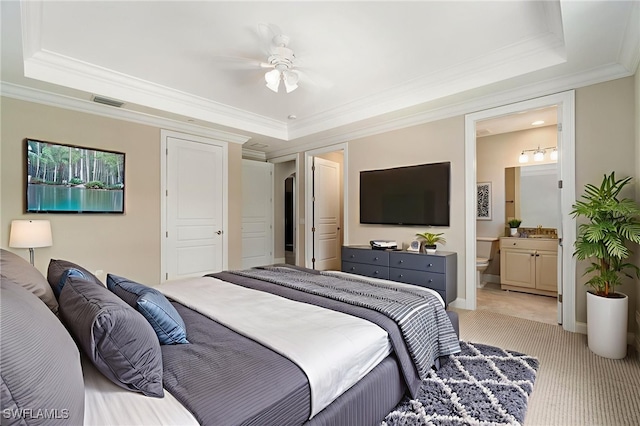 2768 Tiburon Blvd E Unit 202, Naples, FL 34109 - bedroom featuring a tray ceiling, light colored carpet, ornamental molding, connected bathroom, and baseboards