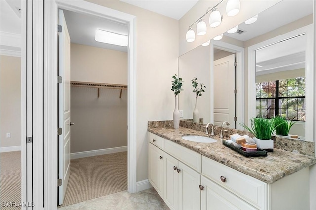 2768 Tiburon Blvd E Unit 202, Naples, FL 34109 - bathroom featuring vanity, a spacious closet, and baseboards
