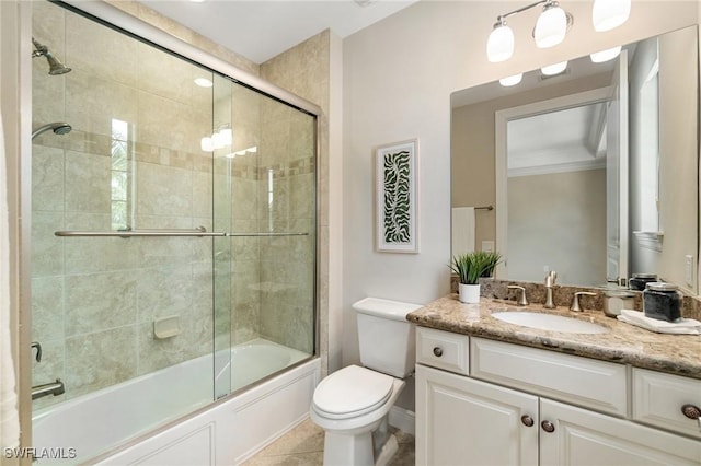 2768 Tiburon Blvd E Unit 202, Naples, FL 34109 - bathroom with vanity, toilet, bath / shower combo with glass door, ornamental molding, and tile patterned floors