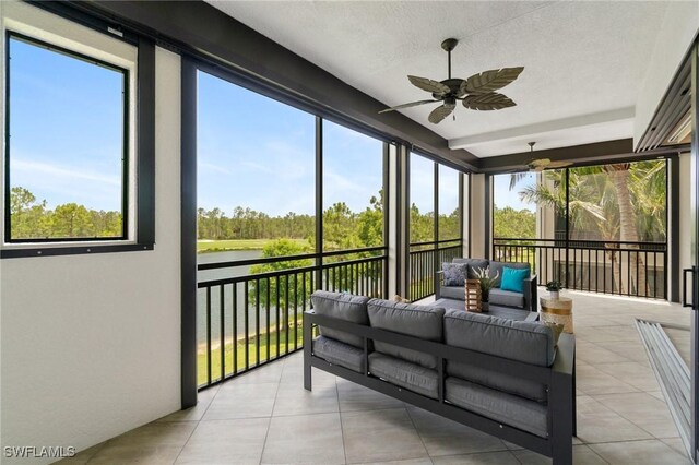 2768 Tiburon Blvd E Unit 202, Naples, FL 34109 - sunroom / solarium with a water view, a ceiling fan, outdoor lounge area, and view of wooded area
