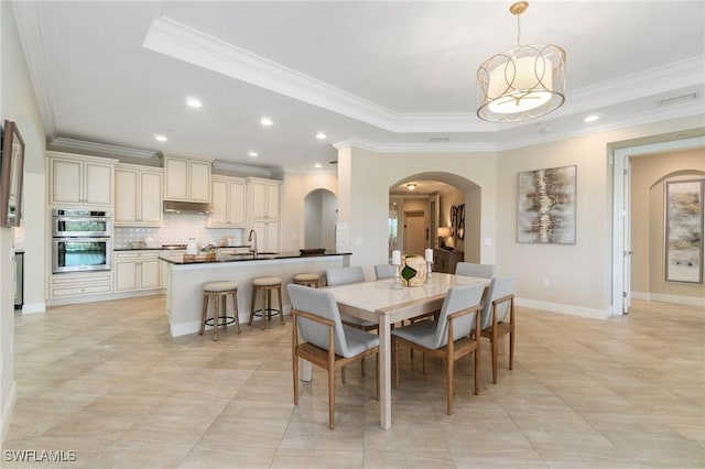 2768 Tiburon Blvd E Unit 202, Naples, FL 34109 - dining area with arched walkways, ornamental molding, recessed lighting, a tray ceiling, and baseboards