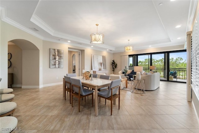 2768 Tiburon Blvd E Unit 202, Naples, FL 34109 - dining area with a tray ceiling, arched walkways, light tile patterned floors, crown molding, and baseboards