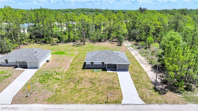 128 Sanborn Dr, Lehigh Acres, FL 33972 - aerial view of property and surrounding area with a forest