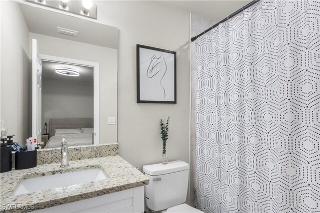 3214 45th St W, Lehigh Acres, FL 33971 - ensuite bathroom with vanity, toilet, and a shower with shower curtain