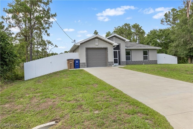 3214 45th St W, Lehigh Acres, FL 33971 - view of front of property with stucco siding, driveway, and a garage