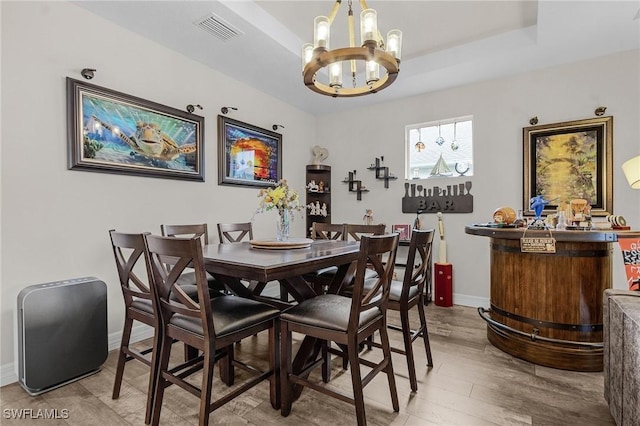 2220 Isle Of Pines Ave, Fort Myers, FL 33905 - dining area with a chandelier, baseboards, and wood finished floors
