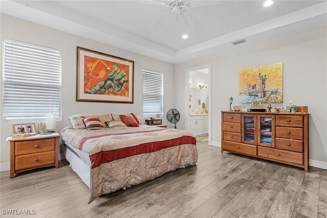 2220 Isle Of Pines Ave, Fort Myers, FL 33905 - bedroom featuring light wood-style floors, recessed lighting, baseboards, a tray ceiling, and ensuite bathroom
