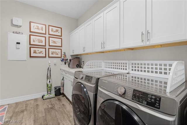 2220 Isle Of Pines Ave, Fort Myers, FL 33905 - laundry room with independent washer and dryer, cabinet space, light wood finished floors, and baseboards