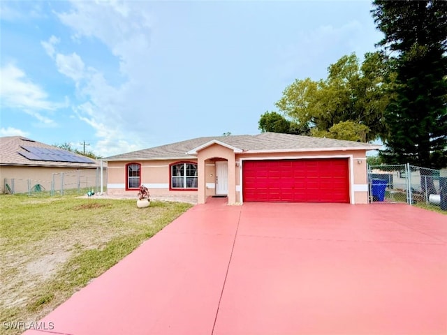 29 Alabama Rd N, Lehigh Acres, FL 33936 - ranch-style home featuring stucco siding, an attached garage, and driveway