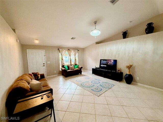 29 Alabama Rd N, Lehigh Acres, FL 33936 - living room with tile patterned flooring, baseboards, and vaulted ceiling