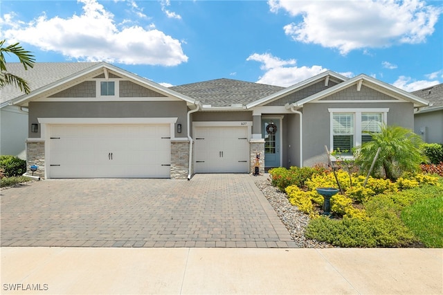 16217 Bluestem Ln, Punta Gorda, FL 33982 - craftsman house with decorative driveway, stucco siding, a garage, and stone siding