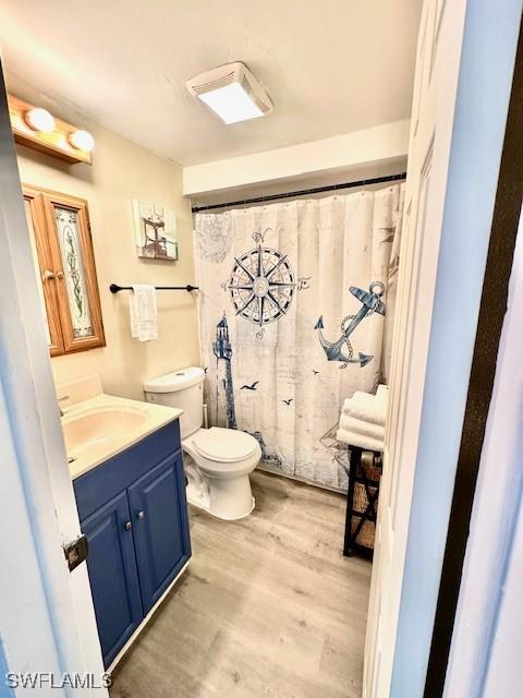 261 Redlin St, North Fort Myers, FL 33903 - bathroom with vanity, toilet, and wood finished floors