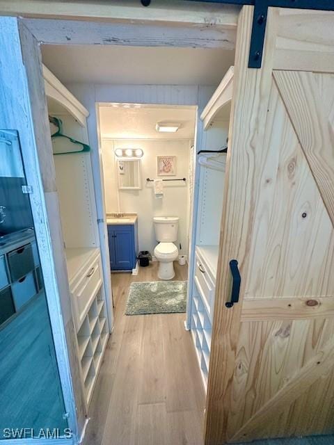 261 Redlin St, North Fort Myers, FL 33903 - bathroom featuring wood finished floors, toilet, and vanity