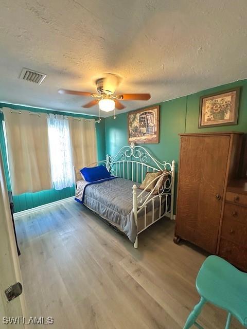 261 Redlin St, North Fort Myers, FL 33903 - bedroom featuring a textured ceiling, wood finished floors, and a ceiling fan