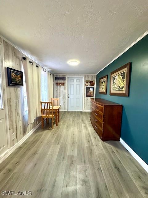 261 Redlin St, North Fort Myers, FL 33903 - dining room featuring a textured ceiling, baseboards, light wood-style floors, and ornamental molding