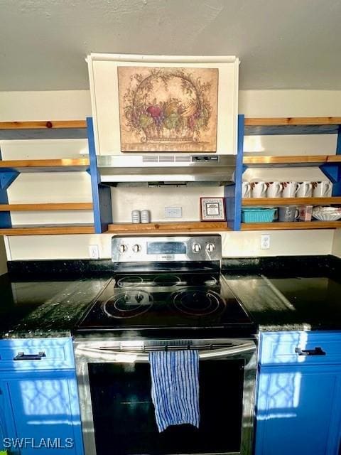 261 Redlin St, North Fort Myers, FL 33903 - kitchen view of electric stove, ventilation hood, and dark countertops