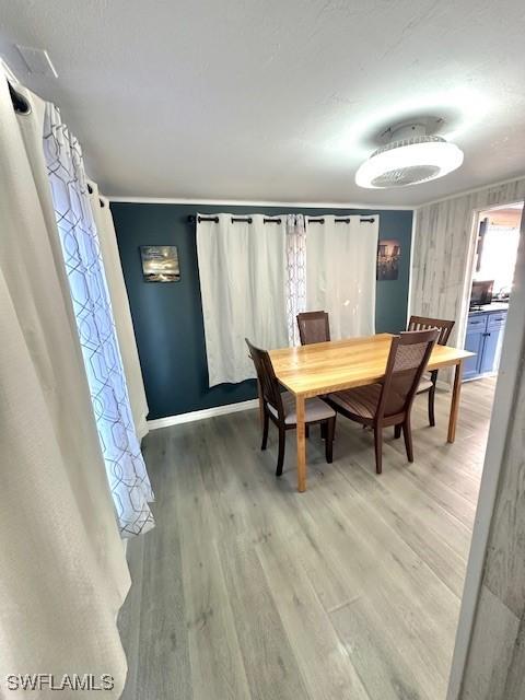 261 Redlin St, North Fort Myers, FL 33903 - dining area featuring light wood finished floors and baseboards