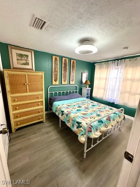 261 Redlin St, North Fort Myers, FL 33903 - bedroom with a textured ceiling and wood finished floors