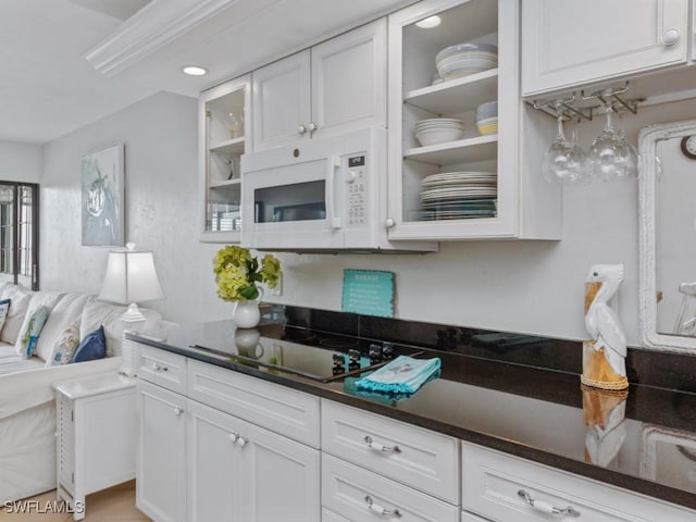 1019 Anglers Cv Unit F302, Marco Island, FL 34145 - kitchen featuring white microwave, white cabinets, black electric stovetop, and glass insert cabinets