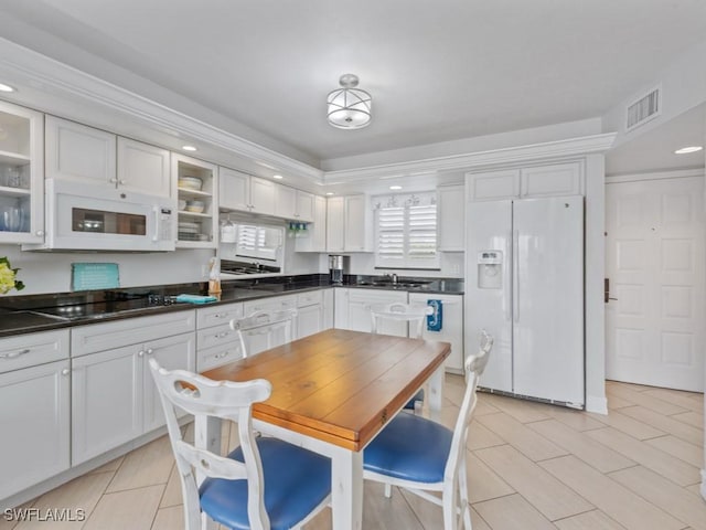 1019 Anglers Cv Unit F302, Marco Island, FL 34145 - kitchen with white appliances, glass insert cabinets, dark countertops, and recessed lighting