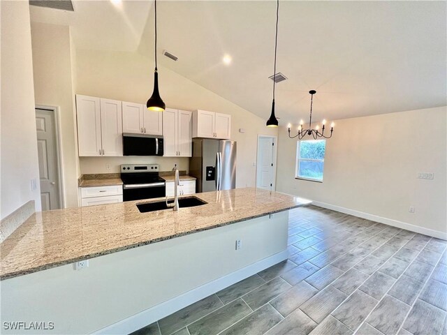 3319 17th St W, Lehigh Acres, FL 33971 - kitchen with stainless steel appliances, a sink, white cabinets, a chandelier, and light stone counters