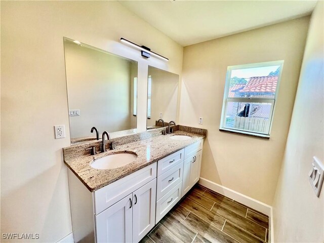 3319 17th St W, Lehigh Acres, FL 33971 - full bathroom featuring double vanity, baseboards, and wood tiled floors