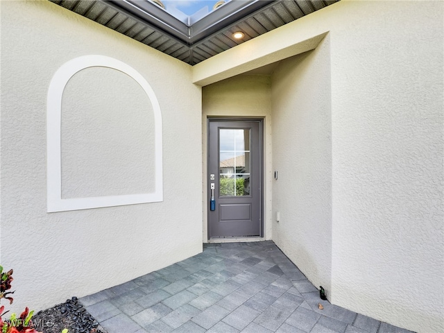 14033 Pine Lodge Ln, Fort Myers, FL 33913 - view of exterior entry with stucco siding